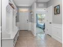Bright and airy foyer with a white bench and view to a bedroom at 603 Lazio Cir, Debary, FL 32713