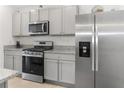 Modern kitchen featuring stainless steel appliances and granite countertops at 603 Lazio Cir, Debary, FL 32713