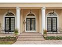 Elegant entryway with three sets of double doors and columns at 6220 Cartmel Ln, Windermere, FL 34786