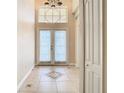 Bright and spacious entryway with tile floors and double doors at 6808 Cherry Grove Cir, Orlando, FL 32809