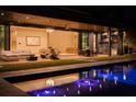 Inviting pool area with outdoor kitchen and seating at night at 8968 Bay Cove Ct, Orlando, FL 32819