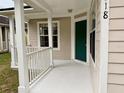 Quaint front porch with white railing and green door at 118 Mandrake St, Orlando, FL 32811