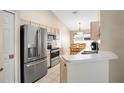 Modern kitchen featuring stainless steel appliances and light wood cabinets at 120 Casterton Cir, Davenport, FL 33897