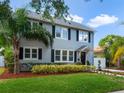 Two-story gray house with black shutters, nicely landscaped front yard at 1375 Suffolk Rd, Winter Park, FL 32789