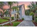 Two-story gray house with black shutters, landscaped yard, and driveway at 1375 Suffolk Rd, Winter Park, FL 32789