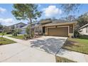 A charming home with a beautifully landscaped yard and ample parking on a sunny day with blue skies at 1721 Lakelet Loop, Oviedo, FL 32765