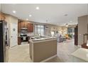 Open concept kitchen with a granite island, stainless steel appliances, and views of the living area at 1721 Lakelet Loop, Oviedo, FL 32765