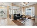 Inviting living room featuring archways, wood and tile flooring, and a large window for ample natural light at 1721 Lakelet Loop, Oviedo, FL 32765