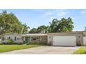 Beautiful single-story home with a detached two-car garage and lush landscaping, great curb appeal at 1792 Killarney Dr, Winter Park, FL 32789