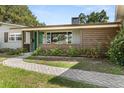 Paver walkway to front door with modern wood siding and beautiful landscaping at 1792 Killarney Dr, Winter Park, FL 32789