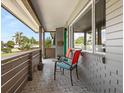 Inviting covered porch with decorative tile, seating, and views of the lush front yard, a relaxing spot at 1792 Killarney Dr, Winter Park, FL 32789