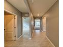 Bright and spacious hallway with tile flooring and arched doorways at 193 Grove Branch Rd, Winter Haven, FL 33880