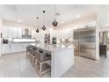 Modern kitchen featuring white cabinets, stainless steel appliances, and a large island at 193 Hampton Loop, Davenport, FL 33837