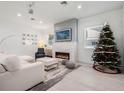 Living room features a white sectional sofa, fireplace, and Christmas tree at 1975 Biscayne Dr, Winter Park, FL 32789