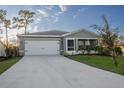 Newly constructed home with a two-car garage and landscaped front yard at 2016 West Pkwy, Deland, FL 32724