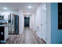 Hallway view from kitchen featuring hard wood floors and white walls and trim at 2016 West Pkwy, Deland, FL 32724
