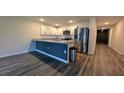 Well-lit kitchen features stainless steel appliances, granite countertops, and modern white cabinetry at 2016 West Pkwy, Deland, FL 32724