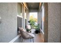A cozy screened patio with neutral colored wicker furniture and potted plants at 2016 West Pkwy, Deland, FL 32724