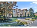 Grand home with stone and stucco exterior, landscaped yard at 2185 Talman Court, Winter Park, FL 32792