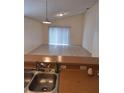 Kitchen features a double sink and view into the living room at 220 Ronaldale Ave, Haines City, FL 33844