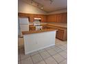 Galley kitchen with wood cabinets and a breakfast bar at 220 Ronaldale Ave, Haines City, FL 33844