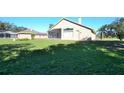 Large backyard with screened patio and grassy area at 3330 Earle Ct, Kissimmee, FL 34746