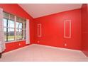 Bright office with red walls, window and hardwood floor at 3330 Earle Ct, Kissimmee, FL 34746