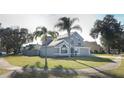 Two-story house with gray siding, palm trees, and a well-maintained lawn at 3473 Hillmont Cir, Orlando, FL 32817