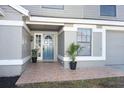 Inviting front entrance with a blue door, tiled flooring and potted plants at 3473 Hillmont Cir, Orlando, FL 32817