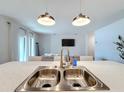 Double stainless steel sink with a modern faucet in a bright kitchen at 429 Tisone Ln, Davenport, FL 33837