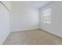 Bright bedroom with neutral walls and carpet at 4462 Lions Gate Ave, Clermont, FL 34711