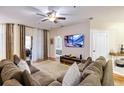 Living room with sectional sofa, hardwood floors, and access to balcony at 4833 Cypress Woods Dr # 4101, Orlando, FL 32811