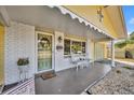 Inviting front porch with seating area and potted plants at 720 E Iris Dr, Orange City, FL 32763