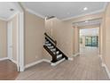 Elegant staircase with dark wood railing and white risers at 8324 Vivaro Isle Way, Windermere, FL 34786