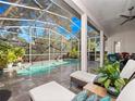 Inviting screened-in pool area with lounge chairs at 837 Ashbrooke Ct, Lake Mary, FL 32746