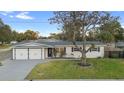 Refreshed ranch-style house featuring a two-car garage and spacious yard at 105 Clyde Ave, Longwood, FL 32750