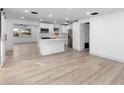 Modern kitchen with white shaker cabinets, island, and stainless steel appliances at 105 Clyde Ave, Longwood, FL 32750