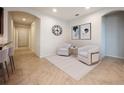 Bright and airy living room with two armchairs and a rug at 121 Whirlaway Dr, Davenport, FL 33837