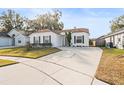 Single-story home with a driveway and well-maintained lawn at 1360 Cherrybark Rd, Apopka, FL 32703