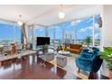 Open floor plan living room with hardwood floors and city views at 150 E Robinson St # 2512, Orlando, FL 32801