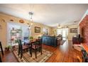 Bright dining room with hardwood floors and view into living room at 1849 Dalton Dr, The Villages, FL 32162