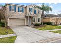 Tan two-story house with blue front door and palm trees at 3464 Julius Estates Blvd, Winter Haven, FL 33881