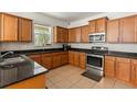 Spacious kitchen with wood cabinets, granite counters and stainless steel appliances at 3464 Julius Estates Blvd, Winter Haven, FL 33881