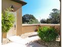 Charming front entry featuring a white front door, decorative bushes, and landscaping at 38207 Sabal Way, Umatilla, FL 32784