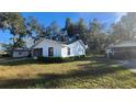 Side view of the house showcasing a carport and landscaping at 436 Avenue G Se, Winter Haven, FL 33880