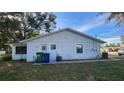 Rear view of the house showing a side entrance and utility area at 436 Avenue G Se, Winter Haven, FL 33880