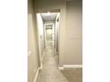 Light-colored hallway with tile flooring at 4476 Lions Gate Ave, Clermont, FL 34711