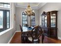 Formal dining room with hardwood floors, a large table, and a display cabinet at 4500 Stone Hedge Dr, Orlando, FL 32817