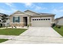 Single story home with a large garage and well maintained front yard at 5093 Meadow Song Dr, Okahumpka, FL 34762