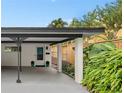 Attached carport with concrete flooring and tropical landscaping at 528 Broadway Ave, Orlando, FL 32803